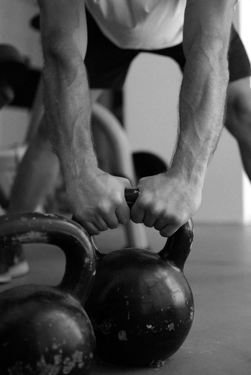man grabbing kettlebel
