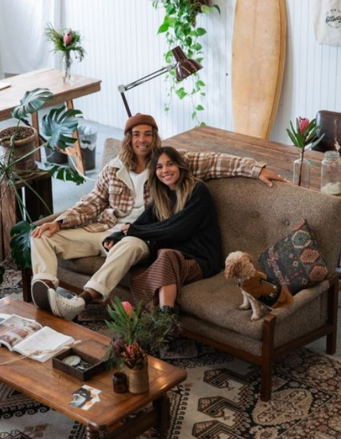 two people sitting on couch in store
