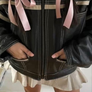leather jacket with bow in hair and skirt