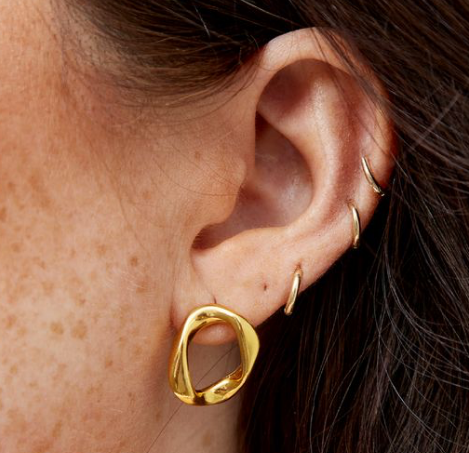 women with gold hoops in